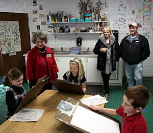 Principal Pam Pyzyk, left, and new parents Ryan and Sharon Roberts observe an art class at St. John Vianney School, Brookfield, on Friday, Jan. 18. The Roberts, who moved to Wisconsin from Kansas, recently enrolled their children at St. John Vianney. (Catholic Herald photo by Allen Fredrickson)