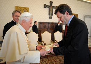  Pope Benedict XVI receives his book "Light of the World: The Pope, the Church, and the Sign of the Times" from its writer, German Catholic journalist Peter Seewald, during a 2010 meeting at the Vatican. The German biographer said the pope was exhausted and disheartened well before he announced Feb. 11 he would resign at the end of the month. (CNS photo/L'Osservatore Romano via Reuters)