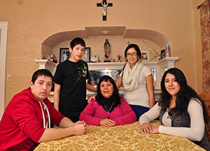 Maria Gonzalez Nuñez poses in her Milwaukee home with her children, Martin, 19, left to right, Nelson, 14; Itzel, 18; and Jasmin, 26. A single mom, Maria, worked more than one job and went back to school in order to send her children to Catholic grade schools and high schools. (Catholic Herald photo by Juan C. Medina)