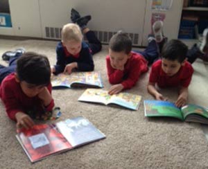 Xavier Roberson, left to right, Jakub Zareba, Emanuel Hernandez and Leonardo Sparks read in their classroom at Wauwatosa Catholic. The school is working toward International Baccalaureate status, a student-centered, hands-on approach to learning. (Submitted photo by Heidi Hernandez)