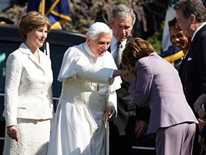 U.S. first lady Laura Bush and President George W. Bush look on as then Speaker of the House Nancy Pelosi kisses Pope Benedict XVI's ring during a welcoming ceremony for the pontiff on the South Lawn of the White House in Washington in this April 16, 200 8, file photo. The pope announced Feb. 11 that he will resign at the end of the month. The 85-year-old pontiff said he no longer has the energy to exercise his ministry over the universal church. (CNS photo/Joshua Roberts)