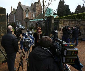 Members of the media gather outside the residence of Cardinal Keith O’Brien of St. Andrews and Edinburgh, Scotland, Feb. 25. (CNS photo/David Moir, Reuters)
