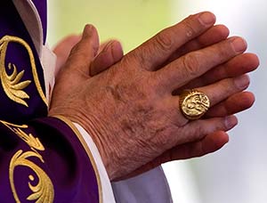 The fisherman's ring - the pope's signet - is seen on the right hand of Pope Benedict XVI, March 28, 2012. (CNS photo/Alessia Giuliani, Catholic Press photo)