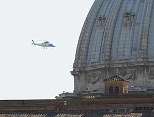 The helicopter carrying Pope Benedict XVI passes the dome of St. Peter's Basilica as the retired pope returns to the Vatican May 2. The pope will live in a monastery in the Vatican Gardens. (CNS photo/Paul Haring)