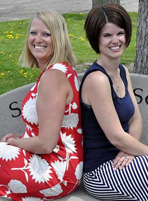 As co-principals of St. Peter Grade School, East Troy, Sarah Halbesma, left, and Ashley Schmidt, “back each other up” in the office, but can also spend part of their weeks at home with their families. (Catholic Herald photo by John Kimpel)
