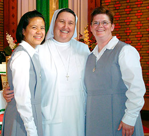 Sr. Jennifer Kane, right, stands with Srs. Elfie Del Rosario, left, and Phyllis Neaves following her official entrance into the novitiate in 2011. (CNS photo/courtesy Sr. Jennifer)