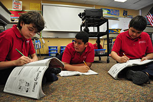 Fifth-graders Joshua Jerominski, left to right, Xavier Colon and Victor Chavez, work together in a language arts class at Nativity Jesuit Middle School on Monday, May 6. (Catholic Herald photos by Juan C. Medina)