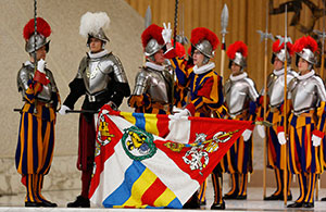A Swiss Guard recruit takes his oath during the swearing-in ceremony for 35 recruits in Paul VI hall at the Vatican May 6. New recruits are sworn in every May 6 to commemorate the day 147 Swiss Guards died saving Pope Clement VII’s life during the 1527 sack of Rome. (CNS photo/Paul Haring)