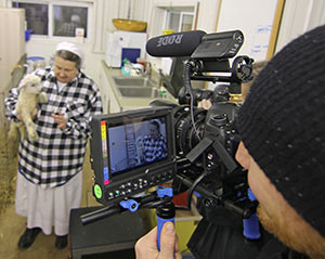 Photojournalist Jaka Vinsek of Carolyn Jones Productions in New York films Sr. Stephen Bloesl, a Sister Servant of Christ the King, of Villa Loretto Nursing Home in Mt. Calvary on Friday, April 18. Sr. Stephen is one of six nurses from around the country to be part of a feature-length film tentatively titled “The American Nurse.” (Catholic Herald photo by Steve Wideman)