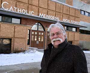Shortly after his last day in a 40-year-career at Catholic Memorial High School, Waukesha, Pat Farrell stands outside the school where he spent 25 years as an English teacher and coach and 15 more in administrative roles. (Catholic Herald photo by Allen Fredrickson)