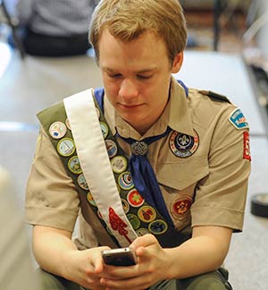 Pascal Tessier, 16, from Kensington, Md., who was facing expulsion from the Boy Scouts because he is gay, sends out a text message on his phone after a resolution to allow openly gay Scouts in the Boy Scouts of America was passed May 23. The vote came during the organization's annual meeting being held in the Dallas suburb of Grapevine, Texas. (CNS photo/Michael Prengler, Reuters)