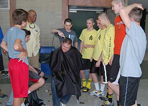 Greg Von Rueden’s teammates on the West Allis Lightning volleyball club take turns shaving the head of coach Ryan Thompson. The players shaved their heads in solidarity with Greg. Player Andre Sydnor organized the event on April 28 at Nathan Hale High School, West Allis. (Catholic Herald photo by Ricardo Torres)