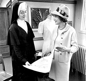 School Sister of Notre Dame Aloyse Hessburg, left, and Mrs. James Robb look at the design of the garment Sr. Aloyse made for Mrs. Robb’s son’s marriage to President Johnson’s daughter Lynda Bird Johnson in this 1967 photo. (Milwaukee Journal Sentinel photo submitted courtesy Mount Mary College)