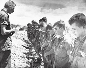 Maryknoll Fr. Vincent R. Capodanno, a Navy chaplain killed while serving with the Marines in Vietnam, is pictured ministering in the field in an undated photo. (CNS photo/courtesy Maryknoll Fathers and Brothers)