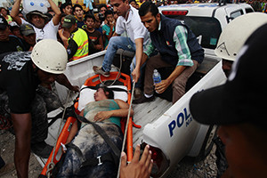 An injured woman on a stretcher is carried into a vehicle by rescue workers in Pedernales, Ecuador, April 17, after an earthquake struck the previous day off the country's Pacific coast. At least 272 people died, nearly 3,000 were injured and thousands were left homeless in the magnitude-7.8 earthquake. (CNS photo/Jose Jacome, EPA)