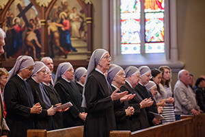 Members of the Little Sisters of the Poor pray during Mass at the Basilica of the Sacred Heart at the University of Notre Dame in Indiana April 9. Later the congregation was awarded the Evangelium Vitae Award for outstanding service to human life, presented annually since 2011 by the university's Center for Ethics and Culture. (CNS photo/Peter Ringenberg, Notre Dame Center for Ethics and Culture)