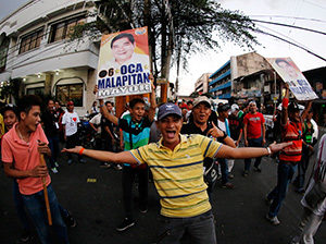  Filipinos gather in the street after national elections in Caloocan City, Philippines. (CNS photo/Francis R. Malasig, EPA)