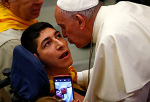 Pope Francis kisses a disabled young man during a special audience with members of Doctors with Africa at the Vatican May 7. (CNS photo/Tony Gentile, Reuters) 