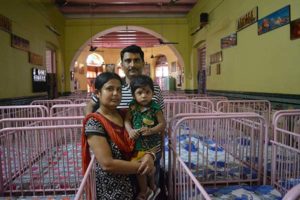 Anirban Mukherjee and his wife, Sampa, pose May 2 with their 17-month-old son Anirban at Shishu Bhavan, the Missionaries of Charity children's home in Kolkata, India. The parents adopted Anirban from the home in April 2015 and call him "the gift from the saint of Kolkata, Mother Teresa." (CNS photo/Saadia Azim)