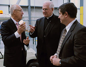  Elder Don R. Clark, of the Church of Jesus Christ of Latter-day Saints, explains to Archbishop Joseph E. Kurtz of Louisville, Ky., president of the U.S. Conference of Catholic Bishops, that much of the food the LDS Church distributes to the needy has a church label. They are shown May 4 at the LDS Church's Utah Bishops' Central Storehouse in Salt Lake City, which Archbishop Kurtz toured during a visit to Utah to meet with Mormon leaders. (CNS photo/Marie Mischel, Intermountain Catholic) 