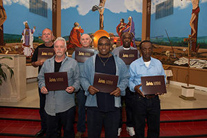 The Loyola Institute for Ministry graduates who earned their certificates in pastoral studies at the Louisiana State Penitentiary in Angola, La., on April 29 are back row, from left, John Balfa, Milburn Bates, Lester Williams and, front row, William Kirkpatrick, Herman Tureaud and Felton Ledet. (CNS photo/Kyle Encar, courtesy Loyola University)