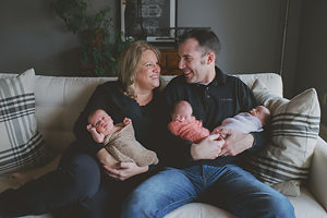 Kevin and Cari Campbell hold their 7-week-old adopted triplets in their Dubuque home in this photo taken in late February. The couple adopted the children after learning their birth mother planned to abort them if she could not find someone to take all three. (Photo courtesy Abbi Triphan Photography)