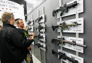 Men view guns May 21 during the National Rifle Association's Annual Meetings & Exhibits show in Louisville, Ky. Two U.S. Catholic prelates called for a ban on the sale of military-style assault weapons, saying they have no place in the hands of civilians.(CNS photo/John Sommers II, Reuters)