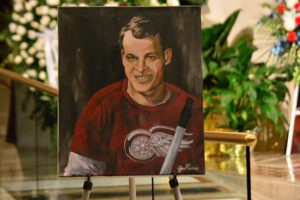 A portrait of Detroit Red Wings great Gordie Howe is displayed next to his casket June 15 inside the Cathedral of the Most Blessed Sacrament in Detroit. Howe, the man forever known as "Mr. Hockey," died June 10 at age 88.(CNS photo/Mike Stechschulte, The Michigan Catholic)