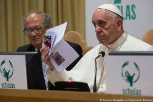 Pope Francis shows photos of killed children during a meeting of Scholas Occurrentes at the Vatican May 29. The Scholas Occurrentes organization, which the pope also supported as archbishop of Buenos Aires, Argentina, promotes a "culture of encounter" through art, sports and technology. (CNS photo/L'Osservatore Romano, handout)