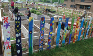 St. John the Evangelist School teachers use “garden-themed lessons” to teach students nutrition, math, science, art, reading and prayer while allowing them to be outside and working with their hands. Students also took pieces of the garden fence home to paint.