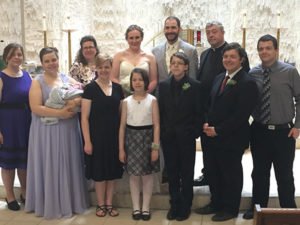 The Zampino family pose for a photo at St. Margaret Mary Parish, Milwaukee, following the May 21 wedding of David Jr. and Lisa (pictured back row center). Also pictured are Teresa, left to right, Maria holding Grace, Michele, Elizabeth, Gianna, Philip, Fr. David Zampino, John Paul and Thomas Becket. (Submitted photo courtesy the Zampino family)