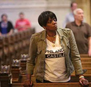 Sharon James-Abba listens to Archbishop Bernard A. Hebda of St. Paul and Minneapolis during a July 8 Mass for peace and justice at the Cathedral of St. Paul. The Mass was offered in response to the July 6 shooting death of St. Paul resident Philando Castile by a police officer. (CNS photo/Dave Hrbacek, The Catholic Spirit) 