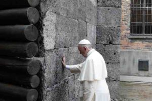 Pope Francis touches the death wall at the Auschwitz Nazi death camp in Oswiecim, Poland, July 29. (CNS photo/Paul Haring) See POPE-POLAND-DEATH-CAMPS July 29, 2016.