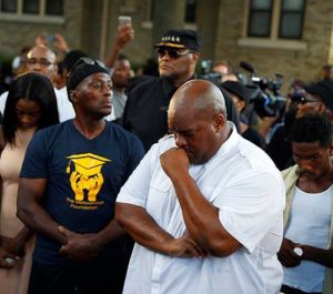 Community members attend a vigil Aug. 14 following the police shooting of a man in Milwaukee the previous day. (CNS photo/Aaron P. Bernstein, Reuters)