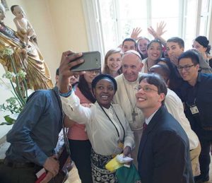 Pope Francis poses for a selfie with young people attending World Youth Day during a lunch in Krakow, Poland, July 30. (CNS photo/L'Osservatore Romano, handout)