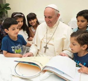 Pope Francis sits with refugee children from Syria at the Vatican Aug. 11. (CNS photo/L’Osservatore Romano via Reuters)