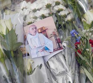 A photo of slain Fr. Jacques Hamel is seen among flowers at a makeshift memorial in Saint-Etienne-du-Rouvray, near Rouen, France, July 27. (CNS photo/Ian Langsdon, EPA)