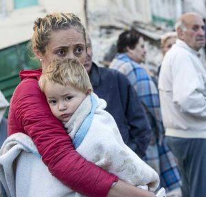 A mother embraces her son in Amatrice, Italy, following an earthquake Aug. 24. (CNS photo/Massimo Percossi, EPA)