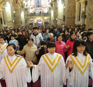 Chinese Catholics pray during a 2015 Mass at a church in Beijing. Prayer and “healthy realism” are needed to ensure progress in Vatican-Chinese relations and, particularly, in promoting a situation in which all Chinese Catholics can feel both fully Catholic and fully Chinese, said Cardinal Pietro Parolin, Vatican secretary of state. (CNS photo/Wu Hong, EPA)