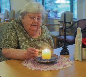 Agnes Imdieke of Albany, Minn., pictured Sept. 6, has been lighting a candle for Jacob Wetterling every morning since he disappeared in October 1989. A Minnesota man confessed to kidnapping and killing the boy during a hearing Sept. 6. (CNS photo/Dianne Towalski, The Visitor) 