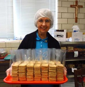 Benedictine Sr. Romaine Kuntz carries a tray of finished Hildegard cookies Sept. 13 at a monastery run by the Sisters of St. Benedict in Ferdinand, Ind., in time for St. Hildegard’s Sept. 17 feast day. The popular product, baked from a recipe written by St. Hildegard, is shipped to buyers across the United States. (CNS photo/Katie Breidenbach)