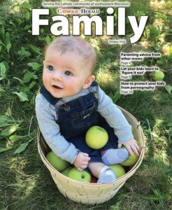 Nolan Bronsted, 6 months, enjoys being in a basket of apples at Elegant Farmer, Mukwonago, in this photo taken last fall. Nolan, now 18 months old, is the son of Nick and Michelle Bronsted, members of St. Charles Parish, Hartland. The photo, taken by Michelle, was selected a winner in the 2016 Catholic Herald Family cover photo contest.