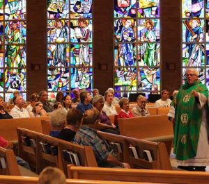 The Hearing Loop recently installed at Holy Cross Church, Mt. Calvary, – one of the St. Isidore Parish sites – is designed to help parishioners like the man above, pictured during Sunday Mass, Aug. 28, who uses hearing aids, hear better during Masses. (Catholic Herald photo by Tracy Rusch)