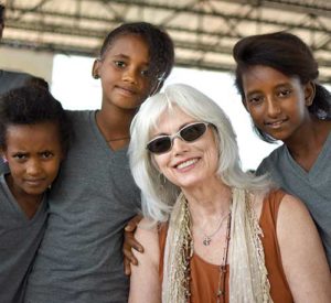 Emmylou Harris poses with young refugees at Adi-Harush refugee camp in northern Ethiopia. Harris, who has won more than a dozen Grammy awards during a 45-year career singing country music, is headlining a series of concerts this fall to benefit Jesuit Refugee Service. (CNS photo/Christian Fuchs, Jesuit Refugee Service/USA)