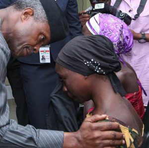 Nigerian Vice President Yemi Osinbajo consoles one of the 21 released Chibok girls Oct. 13 in Abuja. Three Catholic leaders welcomed the release of some of the girls kidnapped in 2014 from a school in Chibok and urged the Nigerian government to prioritize the release of the remaining girls. (CNS photo/EPA)