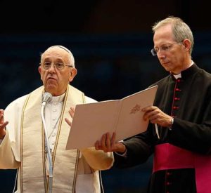 Msgr. Guido Marini, papal master of ceremonies, assists Pope Francis during a Marian vigil in St. Peter’s Square at the Vatican Oct. 8. Msgr. Marini said Catholics should never fight over liturgical music. (CNS photo/Paul Haring)