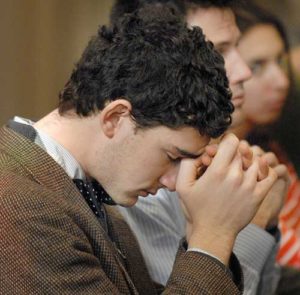 A young man prays during a novena in 2010 at The Catholic University of America in Washington. The Knights of Columbus is urging its members and other U.S. Catholics to pray a novena from Oct. 30 to Nov. 7, the eve of Election Day. (CNS photo/Rafael Crisostomo, El Pregonero)