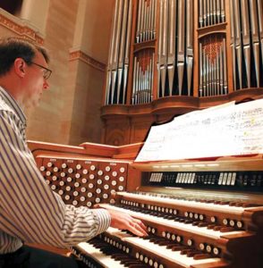 Michael Batcho, the director of music at the Cathedral of St. John the Evangelist, Milwaukee, plays the organ on Thursday, Oct. 13. The instrument, designed by famous recitalist Robert Noehren, is marking its 50th year in the cathedral. (Catholic Herald photo by Allen Fredrickson)
