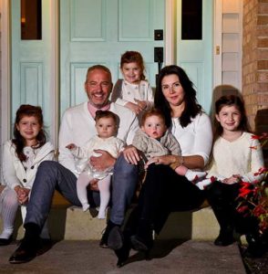 The Cascio family poses for a photo in front of their Menomonee Falls home on Sunday, Oct. 23. Pictured with Michelle and Tim Cascio are their children, Capri, 7, Culen, 1, Chloe, 5, Clare, 3, and 6-month-old Ciara. (Catholic Herald photos by Juan C. Medina)