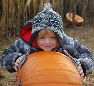 Bailey Wenzler, Jeff Wenzler’s youngest child, is pictured with a pumpkin, taken on the day three years ago when Jeff took his children to the pumpkin farm.